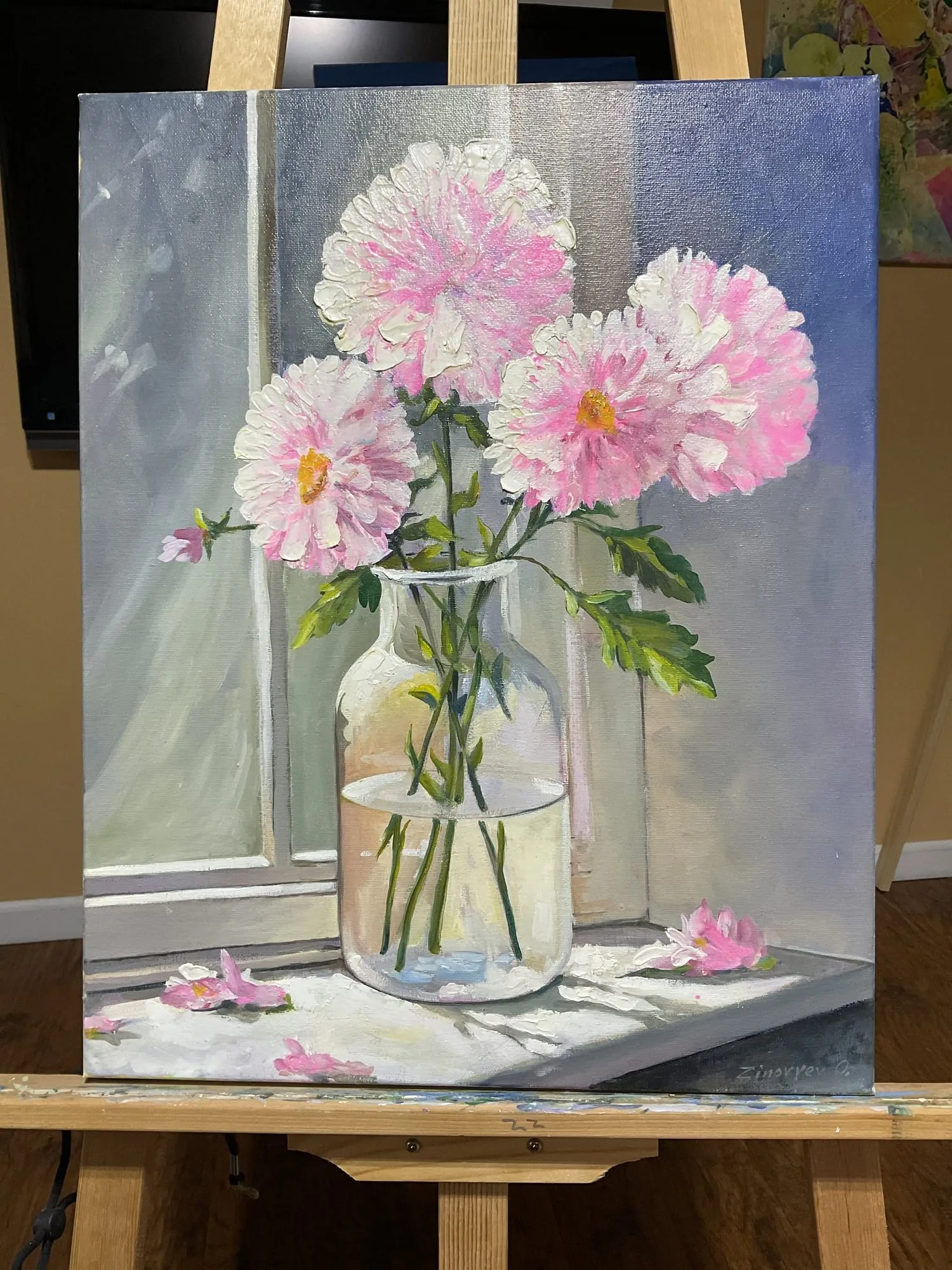 Painting “Flowers in a Bottle” by Oleksandr Zinovyev: Pink dahlias in a tall glass jar on a pale table; photographed on the easel.